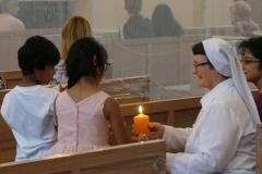 Preparing to pass the light to Fr. Thomson